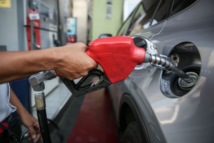 Photo for representation only. A gasoline station attendant fills up a car in Quezon City. ABS-CBN NEWS