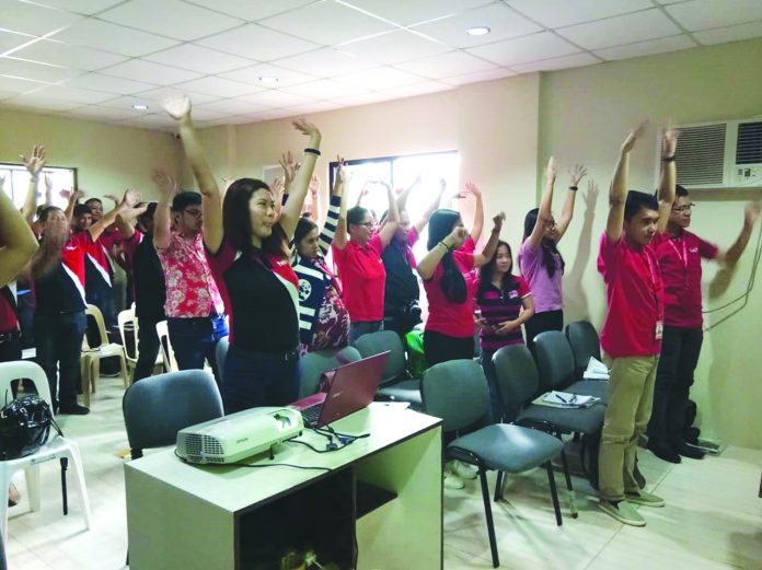 Panay News employees stretch and limber up before a whole day's worth of team building activities at the paper's plant site in Brgy. Mali-ao, Pavia.