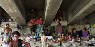 UNDER THE BRIDGE. These Badjaos have found a sturdy refuge under this bridge in Barangay Buhang, Jaro, Iloilo City. Conflict between Muslim separatists and government troops in Mindanao has forced them to flee to Iloilo City. PSTMO PHOTO
