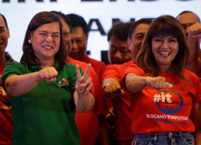 Davao City Mayor Sara Duterte-Carpio (L) and Ilocos Norte Governor Imee Marcos gestures during an alliance meeting with local political parties in Paranaque, Metro Manila