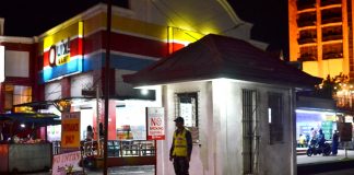 NIGHT SENTINEL. A policeman guards the entrance of Smallville Complex in Mandurriao, Iloilo City. Smallville is a popular strip of bars, restaurants and discotheques. Panay News Photo