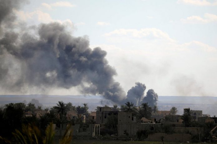 Black plumes of smoke rise in Baghouz, Deir Al Zor province, Syria March 3, 2019. Reuters