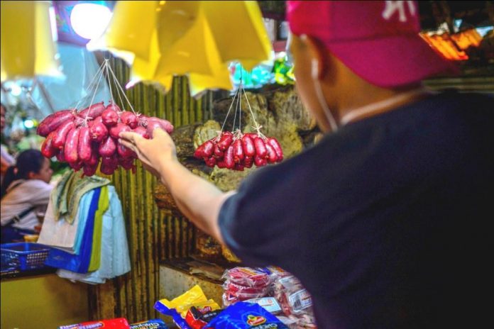 TO BUY OR NOT TO BUY. A buyer checks chorizos at the public market of La Paz district in Iloilo City. Meat vendors complain of a sharp drop in chorizo sales and blame a freak accident at a meat shop – an employee was swallowed by a meat mixer and died. IAN PAUL CORDERO/PN