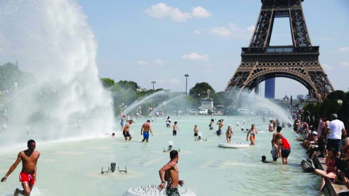 People cool off in the Trocadero fountains across from the Eiffel Tower in Paris as a heatwave hit much of the country, France. The government is postponing exams, opening pools and urging residents to stay hydrated. AP VIA WASHINGTON POST