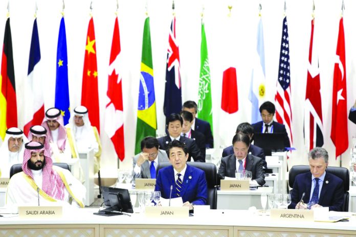 Japan’s Prime Minister Shinzo Abe, front row center, speaks while Saudi Crown Prince Mohammed bin Salman, front row left, and Argentina's President Mauricio Macri, front row right, listen during a working lunch at the Group of 20 (G-20) summit in Osaka, western Japan, Friday, June 28, 2019. AP