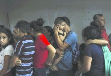 Mexico detains migrants in raid on freight train Detained migrants stand together in a storage room at the back of the Azteca Hotel where they tried to hide from Mexican immigration agents conducting a raid in Veracruz, Mexico, Thursday, June 27, 2019. Under increasing US pressure to reduce the flow of hundreds of thousands of Central Americans through Mexican territory, Mexico's government has stepped up enforcement. AP
