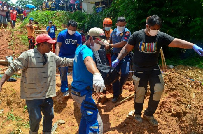 Responders carry one of the body of the three brothers who died due to suffocation inside an underground water tank in Barangay Maindang, Cuartero, Capiz on Wednesday. PDRMMO CAPIZ