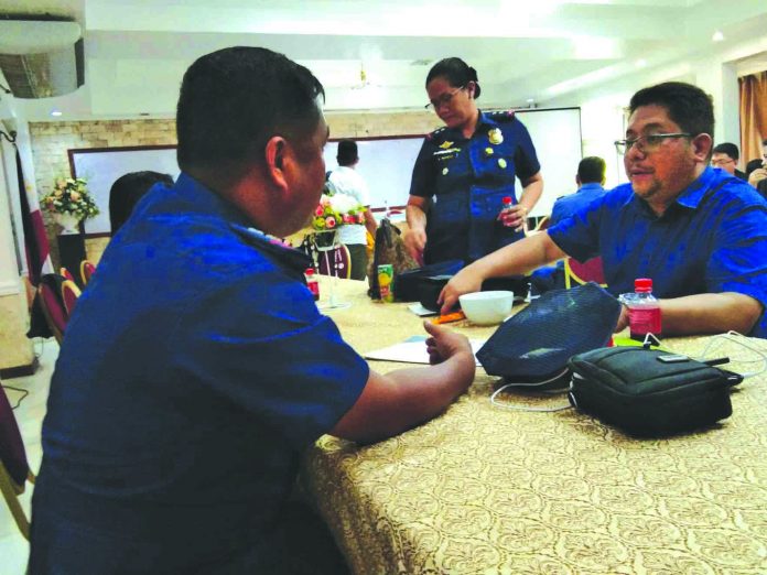 Albert Gregory Potato Councilor Albert Gregory Potato of Roxas City, Capiz confers with city police chief Dante Tayco before the deliberation and declaration of the five city villages as drug-cleared areas by the Regional Oversight Committee in Iloilo City on July 4, 2019. ROXAS CITY PNP