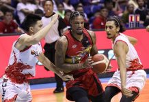 San Miguel Beermen’s Chris McCullough protects the ball against the defense of Phoenix Pulse Fuel Masters’ JC Intal and Alex Mallari. PBA