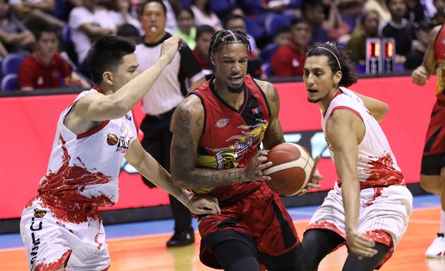 San Miguel Beermen’s Chris McCullough protects the ball against the defense of Phoenix Pulse Fuel Masters’ JC Intal and Alex Mallari. PBA