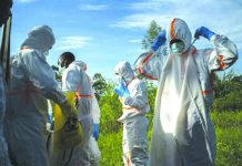 Congo confirms 2nd Ebola case in border city of Goma In this Sunday, July 14, 2019 photo, burial workers put on protective gear before carrying the remains of Mussa Kathembo, an Islamic scholar who had prayed over those who were sick, and his wife, Asiya, to their final resting place in Beni, Congo. AP