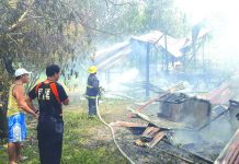 Fire officers spray water using a hose on the remains of the houses that were totally razed in Barangay San Fernando, San Jose, Antique. STEPHEN LOUIE CHECA/PN