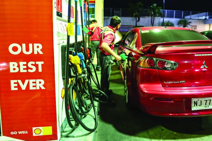 Oil Price Hike A gas station attendant in Metro Manila refuels a private vehicle. RAPPLER
