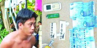 Construction worker Hilberto Reyes sits handcuffed after policemen caught him in an entrapment operation in Barangay Poblacion, Numancia, Aklan on July 26. Recovered from his possession were P8,000 marked money and a cellphone. RODNEL AGUIRRE VIA AKEAN FORUM