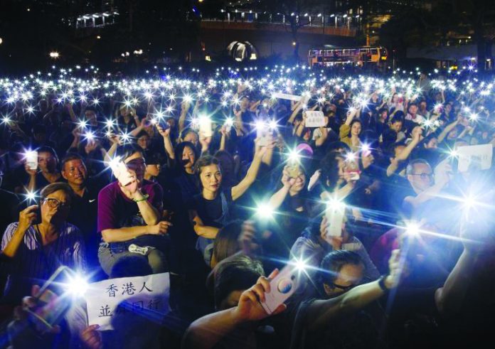 People wave flashlights during a gathering of Hong Kong mothers to show their support for the city’s young pro-democracy protesters in Hong Kong, China, July 5, 2019. REUTERS