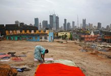 India suffers driest June in five years A woman puts clothes to dry overlooking central Mumbai's financial district skyline, India, June 18, 2019. REUTERS