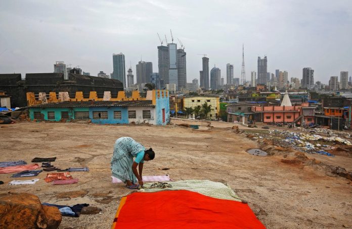 India Heat A woman puts clothes to dry overlooking central Mumbai's financial district skyline, India, June 18, 2019. REUTERS