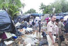 India wall collapse kills 15 people Rescuers and onlookers stand at the spot of a wall collapse in Mumbai, India, Tuesday, July 2, 2019. Nearly a dozen people are feared killed. Building collapses are common in India during the June-September monsoon season, when heavy rains weaken the foundations of structures that are poorly constructed. AP
