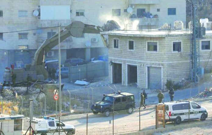 Israel demolition Jerusalem An Israeli machinery demolishes a Palestinian building in the village of Sur Baher which sits on either side of the Israeli barrier in East Jerusalem and the Israeli-occupied West Bank July 22, 2019. REUTERS