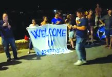 Italy rebuffs German migrant appeal People hold a banner reading “Welcome in Lampedusa” as migrants disembark a rescue boat in the port of Lampedusa, Italy, July 7, 2019, in this still image taken from video footage. REUTERS