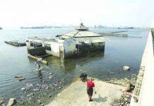 ‘Sinking Jakarta needs giant sea wall’ People walk near a giant sea wall which is used as a barrier to prevent sea water from flowing into land and cause flooding in Jakarta, Indonesia, Saturday, July 27, 2019. Indonesia's President Joko Widodo said in an interview that he wants to see the speedy construction of the giant sea wall to save the low-lying capital of Jakarta from sinking under the sea. AP
