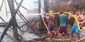 Fire officers, with some help from the residents, sprays water using a hose on the remains of the houses that were totally razed in Purok 3, Barangay Poblacion, Libacao, Aklan. BOY RYAN ZABAL