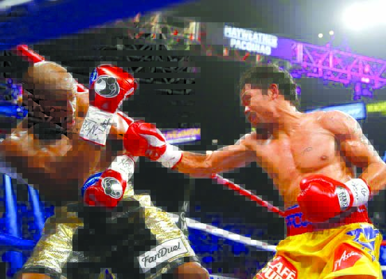 Manny Pacquiao and Floyd Mayweather Jr. Manny Pacquiao throws a right at Floyd Mayweather Jr. during their welterweight unification championship bout on May 2, 2015 at the MGM Grand Garden Arena in Las Vegas, Nevada. Mayweather won.