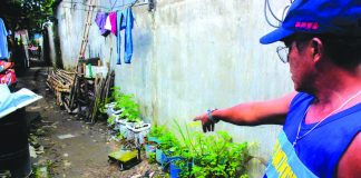 A resident points the location of a stabbing incident between two neighboring families in Barangay Mansilingan, Bacolod City on July 28. Two persons were killed and four others were injured, according to the police. ARCHIE ALIPALO/PN
