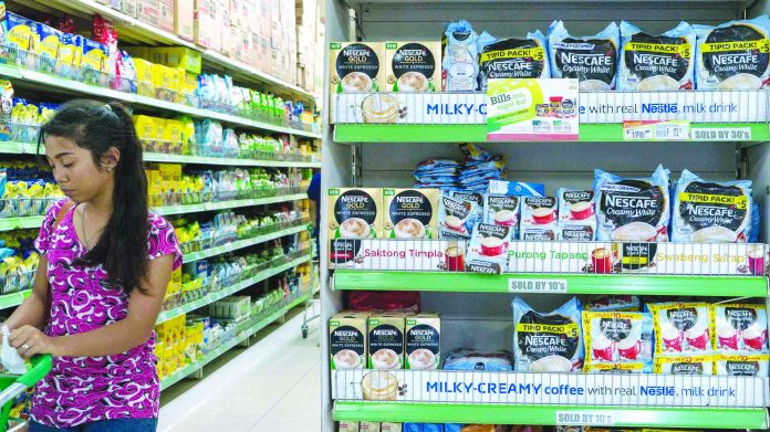 Market A Filipina consumer walks past an aisle of instant coffee at a grocery store in Metro Manila. AP
