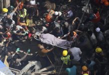Mumbai building collapse kills 10 Rescuers carry the body of a victim at the site of a building that collapsed in Mumbai, India, Tuesday, July 16, 2019. A four-story residential building collapsed Tuesday in a crowded neighborhood in Mumbai, India's financial and entertainment capital, and several people were feared trapped in the rubble, an official said. AP