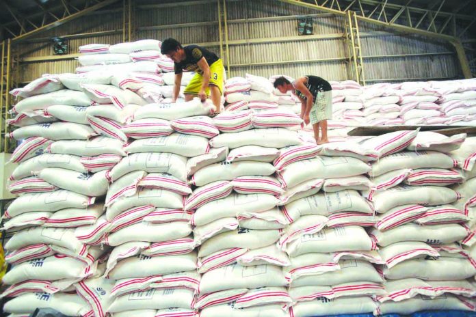 Photo shows workers stacking NFA rice. The BOC said that an average of 256, 445 metric tons per month of rice had been imported since the implementation of the Rice Tarrification Law. GMA NETWORK