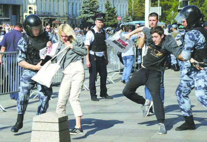 AP Police officers detain people during an unsanctioned rally in the center of Moscow, Russia, Saturday, July 27, 2019. Russian police on Saturday began arresting people outside the Moscow mayor's office ahead of an election protest demanding that opposition candidates be allowed to run for the Moscow city council. AP