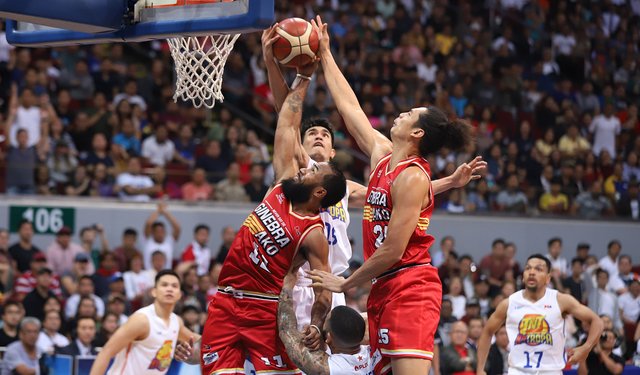 Barangay Ginebra San Miguel Kings’ Stanley Pringle and Japeth Aguilar and TNT KaTropa’s Jeth Troy Rosario battle for the rebound. PBA PHOTO