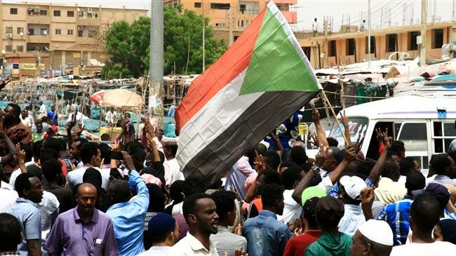 Sudanese people chant slogans and wave Sudanese flags during a demonstration in Khartoum, Sudan. Sudanese people chant slogans and wave Sudanese flags during a demonstration in Khartoum, Sudan. REUTERS