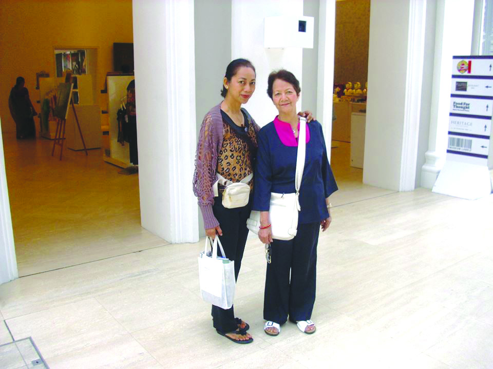At the National Museum of Singapore with my mother. Sling bags are a must for hands-free convenience. Have a hand ready for a shopping bag.