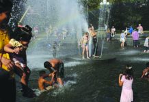 Massive heat wave bakes central, eastern US Families play in the fountain at Washington Square Park in Manhattan, New York, U.S. on July 20, 2019. REUTERS
