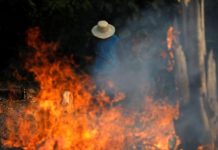 A man works in a burning tract of Amazon jungle as it is being cleared by loggers and farmers in Iranduba, Amazonas state, Brazil, August 20, 2019. Reuters