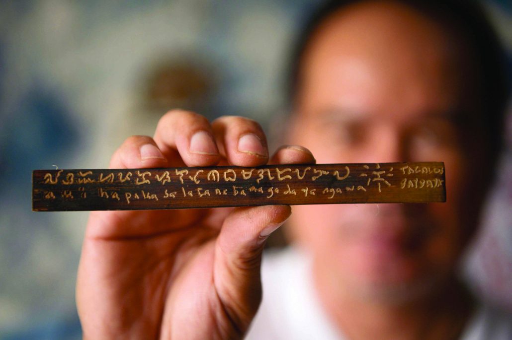 Baybayin script etched onto a piece of wood. AFP