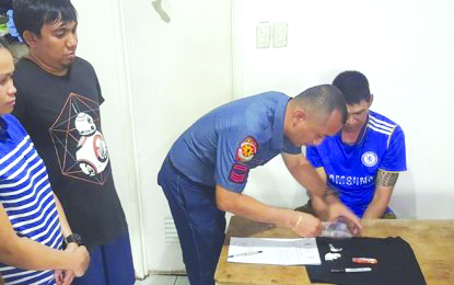 Patrolman Bryn Jephtha Gimotea (seated) is arrested by his training supervisor Senior Master Sergeant Emmanuel Alonsogay (2nd from right) while using marijuana in a pot session Aug. 17. BACOLOD CITY POLICEC STATION 1