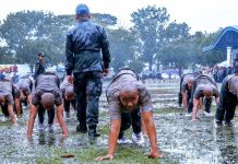 WHEN THE GOING GETS WE AND MUDDY. New police recruits get ready for their pushups during reception rites at the wet and muddy grounds of Camp Delgado, the headquarters of the Police Regional Office 6 in Iloilo City. Four hundred all-male police recruits took oath as members of the Philippine National Police yesterday, Aug. 28, 2019. IAN PAUL CORDERO/PN
