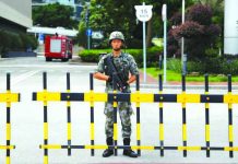 A Chinese People's Liberation Army soldier guards the entrance to the PLA Hong Kong Garrison headquarters in the Central Business District in Hong Kong, China, Aug. 29, 2019. REUTERS