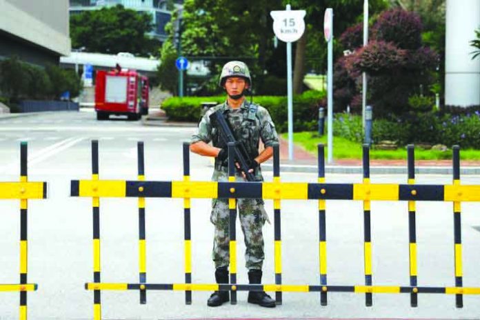 Chinese People's Liberation Army A Chinese People's Liberation Army soldier guards the entrance to the PLA Hong Kong Garrison headquarters in the Central Business District in Hong Kong, China, Aug. 29, 2019. REUTERS