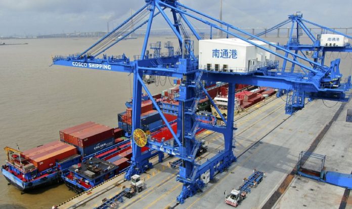 Shipping containers are loaded onto a cargo ship at a port in Nantong in eastern China’s Jiangsu province, Jul. 18, 2019. Chinese foreign ministry spokesman Geng Shuang expressed hope Washington can get along with China and restore “mutually beneficial” trade. AP