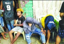 Drug suspects (from left) Cristel Ann Alcazaren, John Mark Distor and Jet Jet Alberto are handcuffed after police officers caught them in an entrapment operation in Barangay VIII, Roxas City on July 31. GLENN BEUP/PN