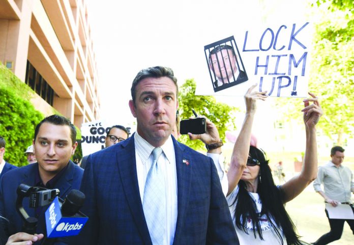 U.S. Rep. Duncan Hunter, R-Calif., leaves federal court after a hearing in San Diego. Hunter, who is facing corruption charges, wants his Sept. 10 trial postponed while his attorneys appeal a judge's refusal a month earlier to dismiss the case. AP