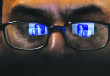 Facebook shuts 216 social media accounts in Myanmar Facebook logo is reflected in glasses in this picture illustration taken April 1, 2019. REUTERS