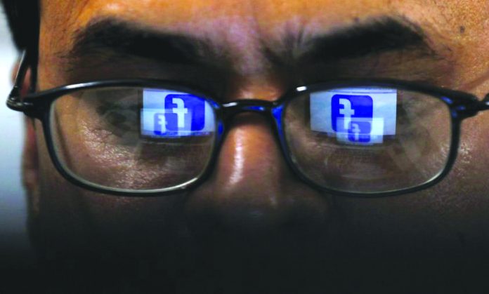 Facebook Facebook logo is reflected in glasses in this picture illustration taken April 1, 2019. REUTERS