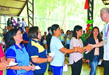 Negros Occidental Gov. Eugenio Jose Lacson (extreme right) congratulates the inducted officers of the Federation of Day Care Workers/Child Development Workers during their 1st Pasundayag celebration held at the Panaad Covered Court in Bacolod City on Aug. 23. Lacson led the distribution of P10.5 million worth of subsidy to the 1,750 daycare workers of the province. NEGROS OCCIDENTAL PIO