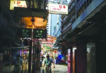 Battered Hong Kong faces economic crisis A man walks down an alley filled with stalls in the Central business district in Hong Kong, China Aug. 22, 2019. REUTERS