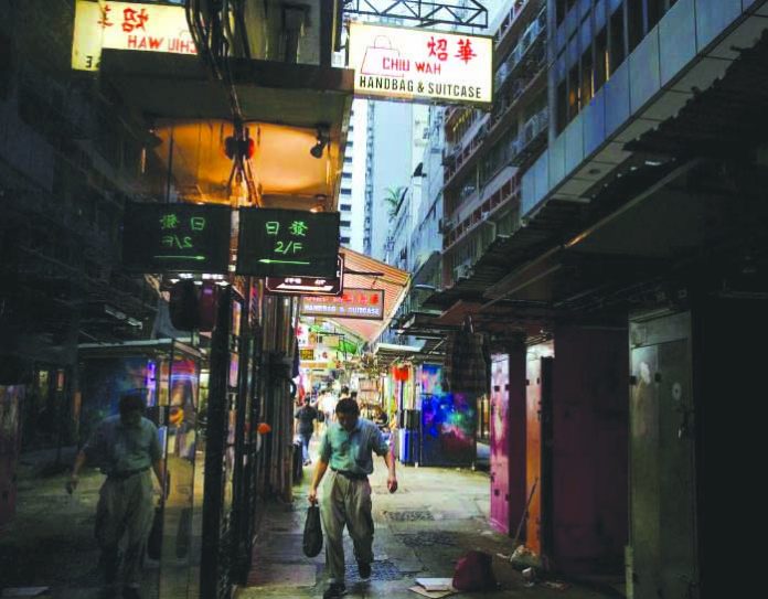 Hong Kong, China A man walks down an alley filled with stalls in the Central business district in Hong Kong, China Aug. 22, 2019. REUTERS